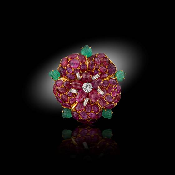 A carved ruby, emerald and diamond brooch