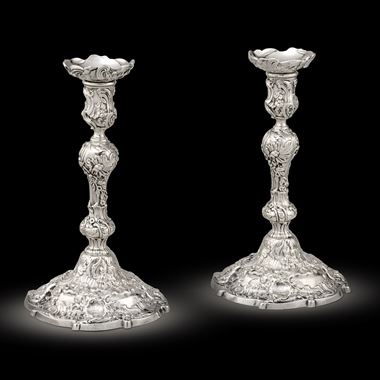 A Pair of George II cast silver Rococo candlesticks