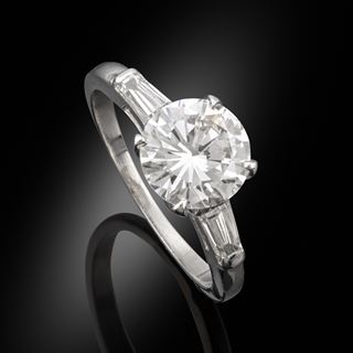 A 1.71ct diamond ring in a platinum mount with baguette cut shoulders