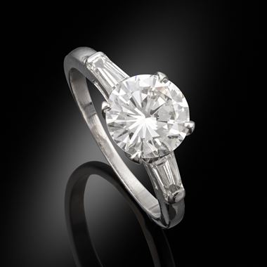 A 1.71ct diamond ring in a platinum mount with baguette cut shoulders