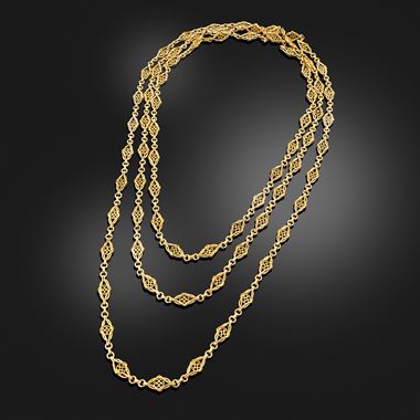A gold long chain necklace with oval and lozenge pattern links, circa 1890