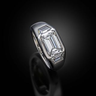 An emerald cut diamond ring in a platinum mount 