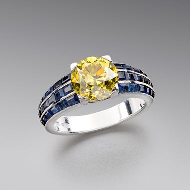 A Fancy Vivid Yellow Diamond and Sapphire Ring