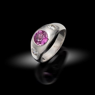 A pink sapphire and diamond gypsy ring
