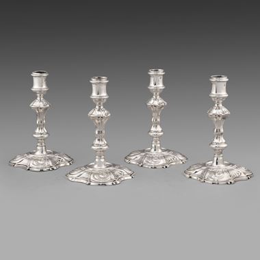 A Set of Four Restrained Rococo Candlesticks