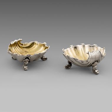 A pair of George III silver shell shaped salts
