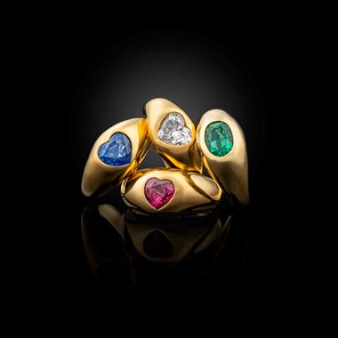 A collection of gem set gypsy rings mounted in 18K gold