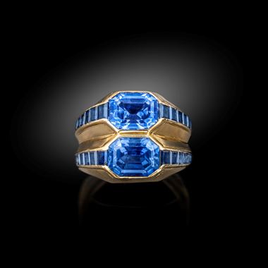 A gold and sapphire double band ring