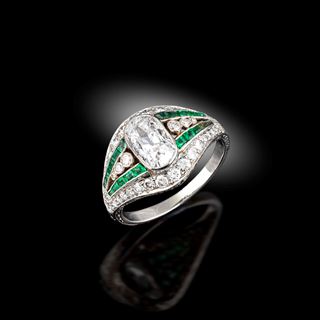 An emerald and diamond ring, circa 1915