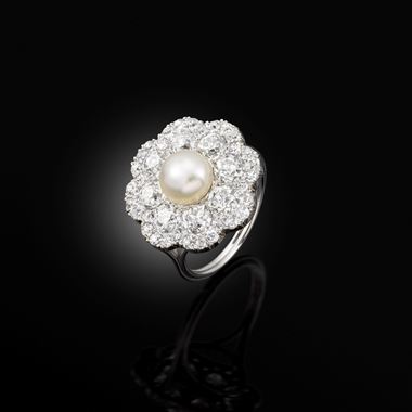 An early 20th century natural pearl and diamond cluster ring, circa 1915