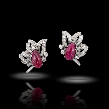 A pair of carved ruby and diamond earrings
