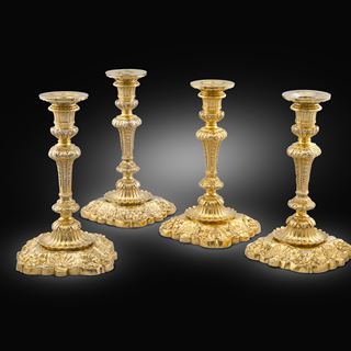 An Important Set of Four Silver-Gilt Royal Candlesticks