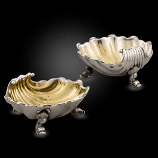 A pair of George III silver shell shaped salts
