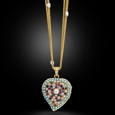 An antique gem-set heart pendant locket on a pearl set gold chain