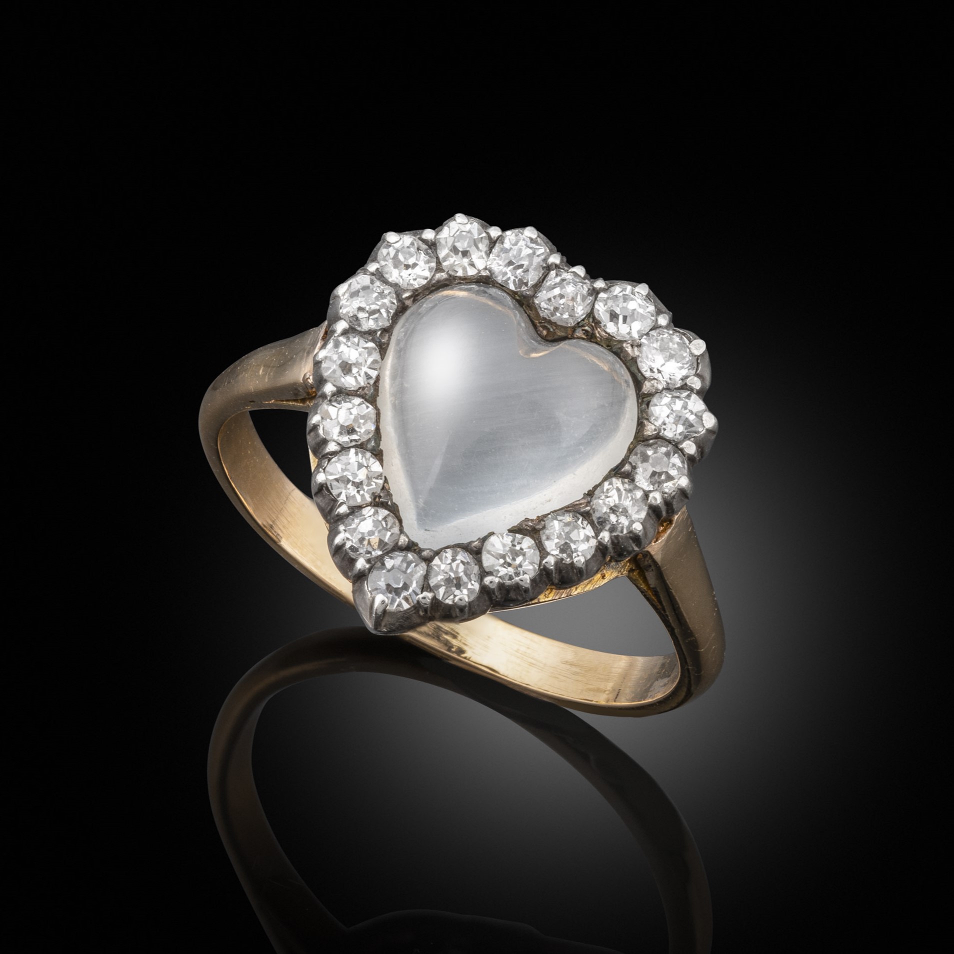An early 20th century moonstone and old cut diamond heart shaped ring