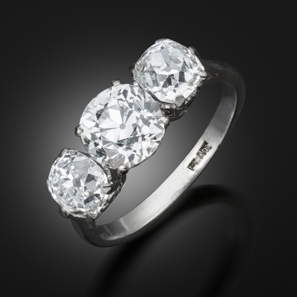 An antique 3 stone old cut diamond ring