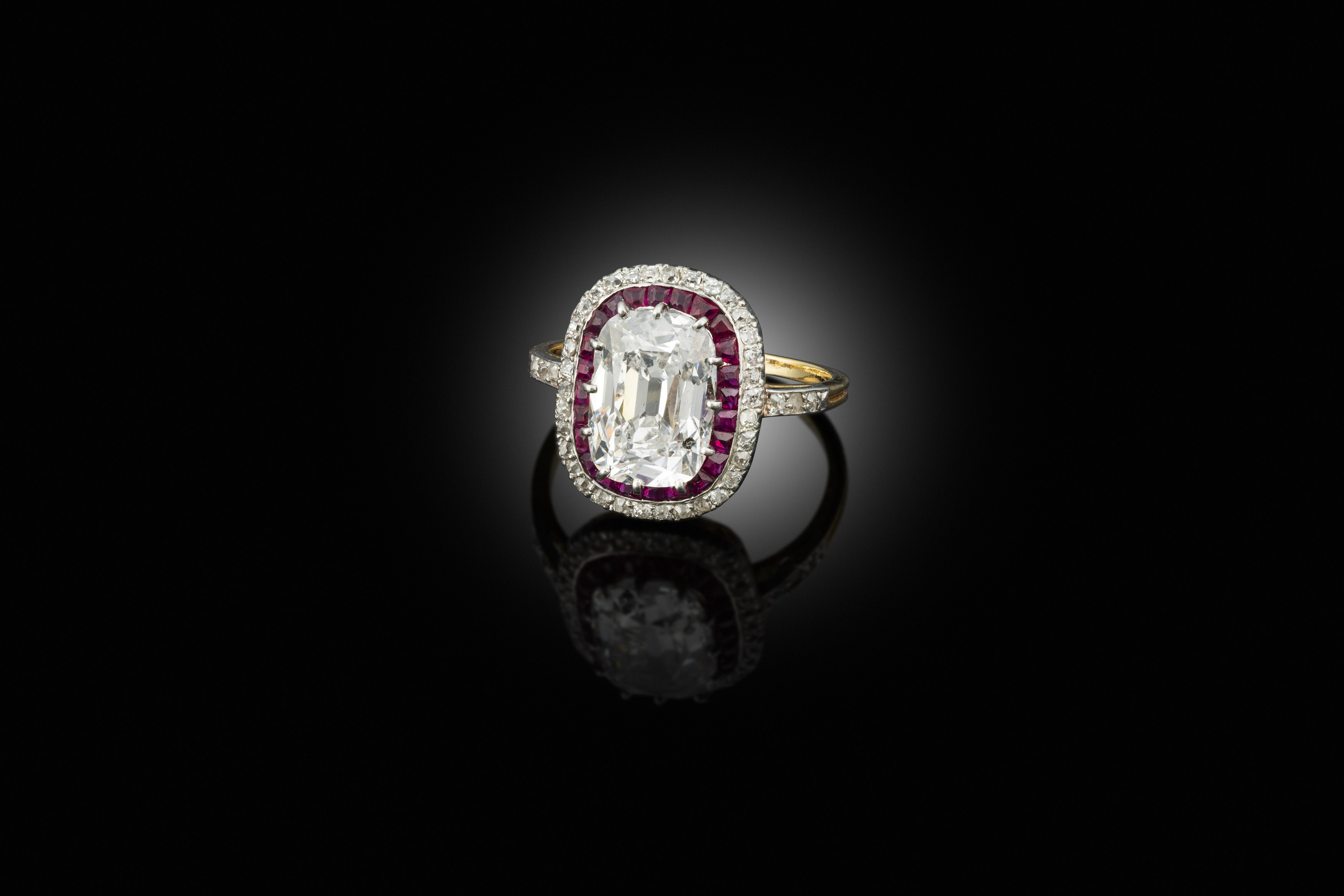 Early 20th century elongated old mine cut diamond, ruby and diamond cluster ring, Circa 1915