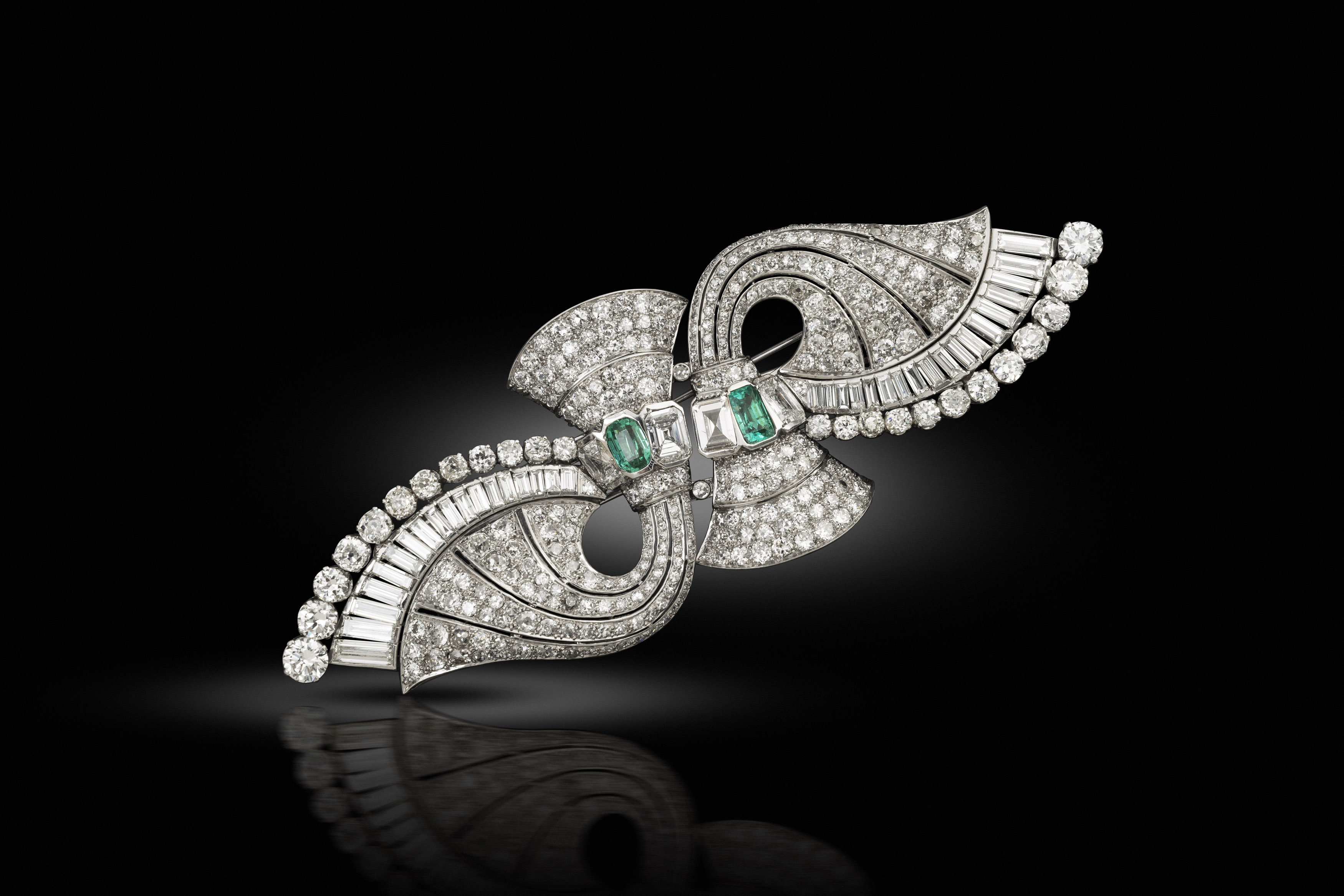 An art deco emerald and diamond double clip