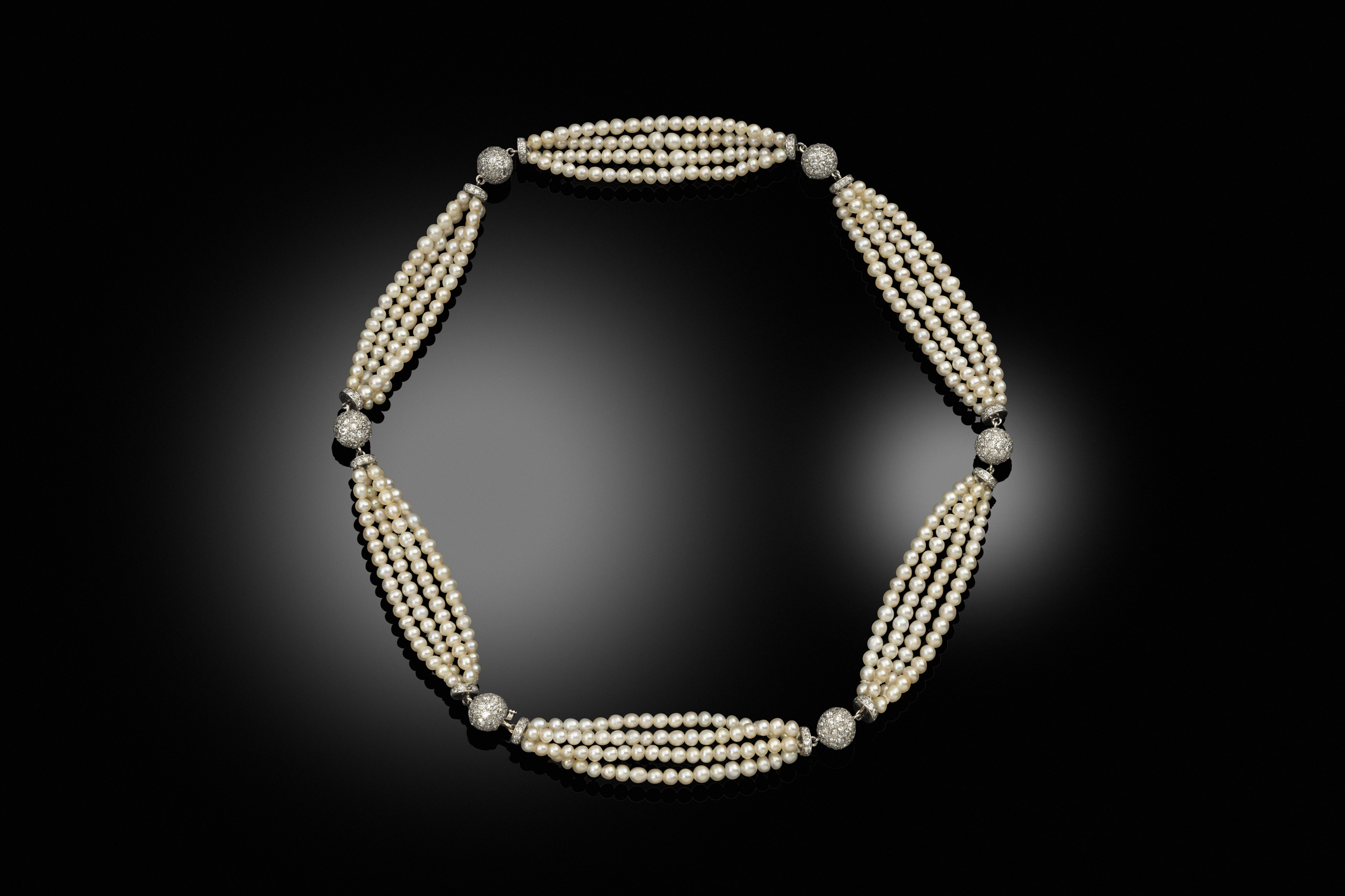 An early 20th century natural seed pearl and diamond necklace