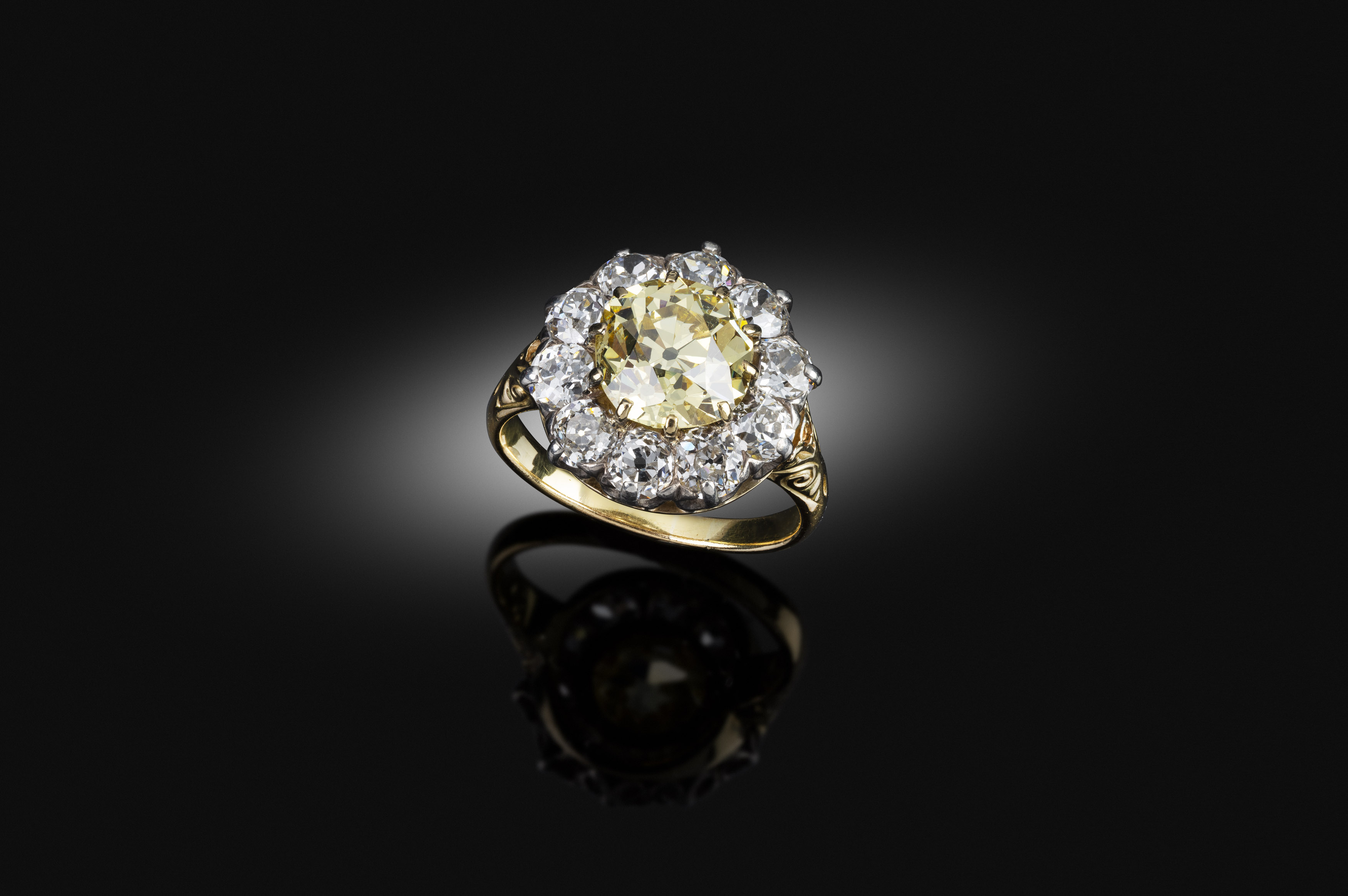 An antique yellow diamond cluster ring