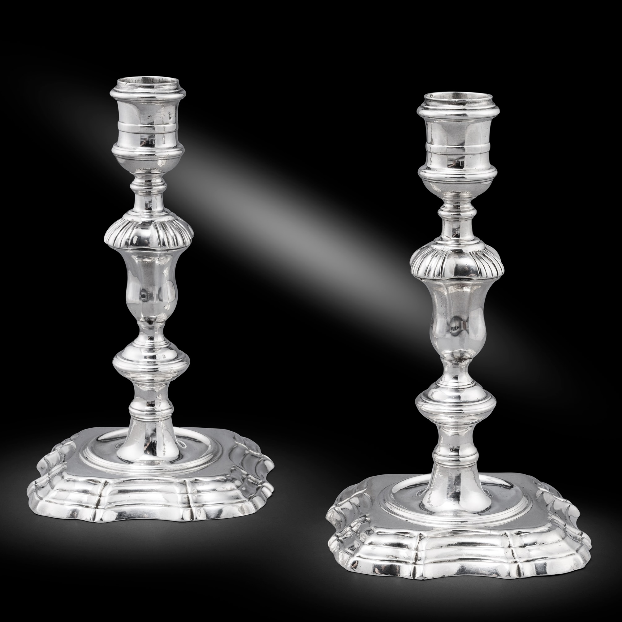 A Pair of George II cast candlesticks