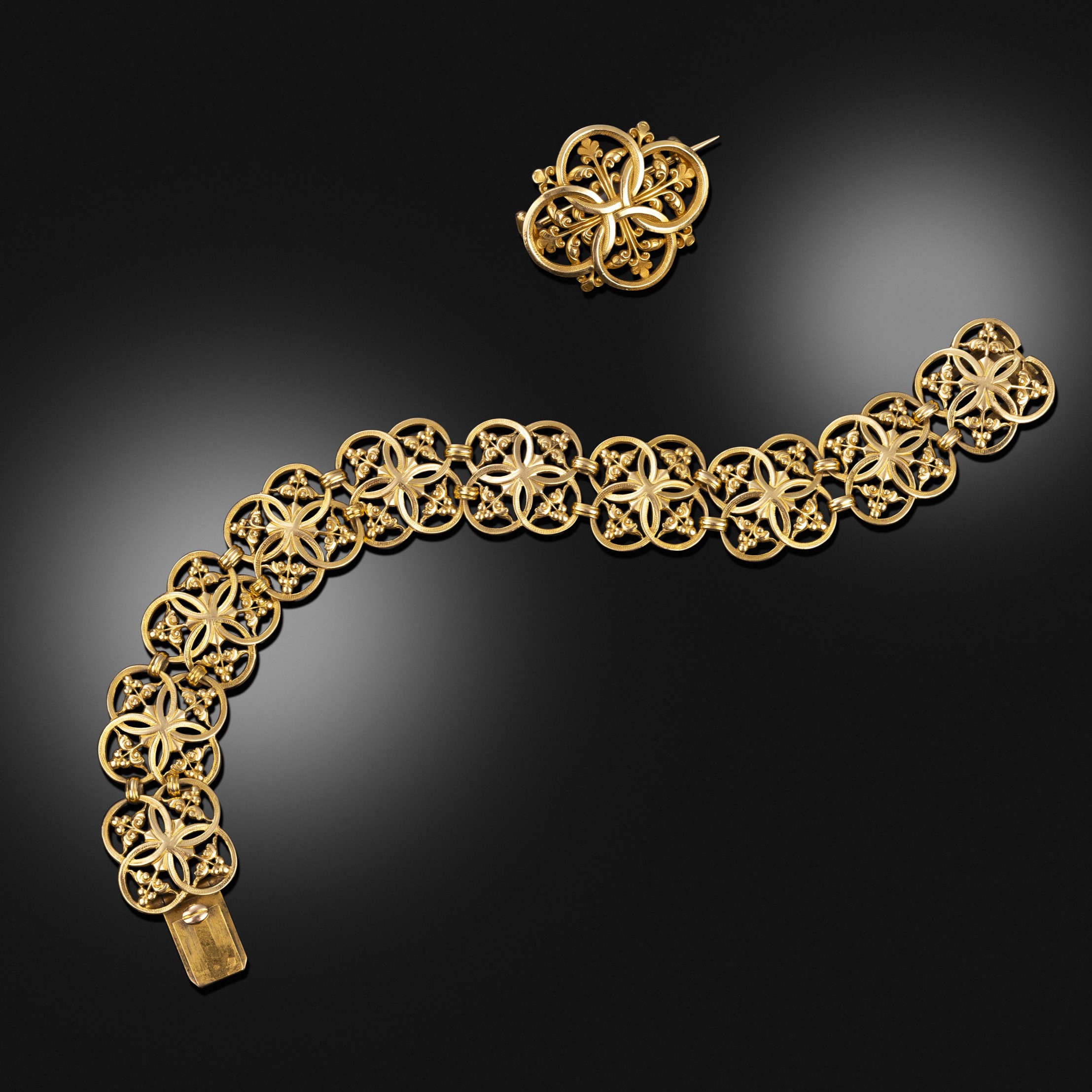  Late 19th century gold openwork quatrelobe bracelet and brooch en suite
