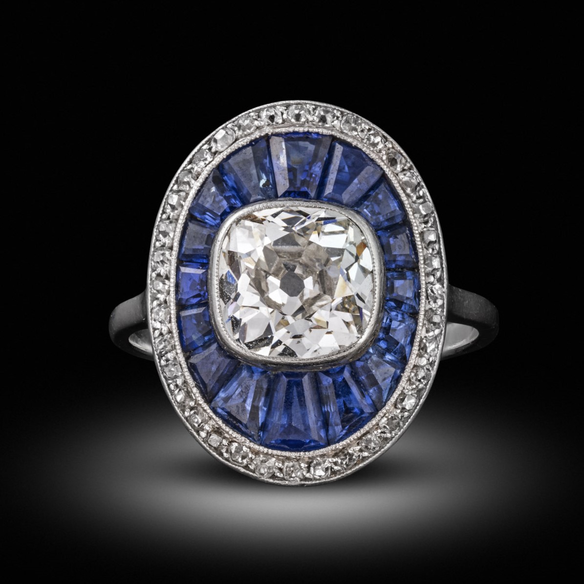A diamond and sapphire cluster ring, circa 1910