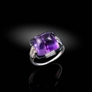 An art deco onyx and diamond dress ring set with a sugarloaf amethyst,  circa 1925