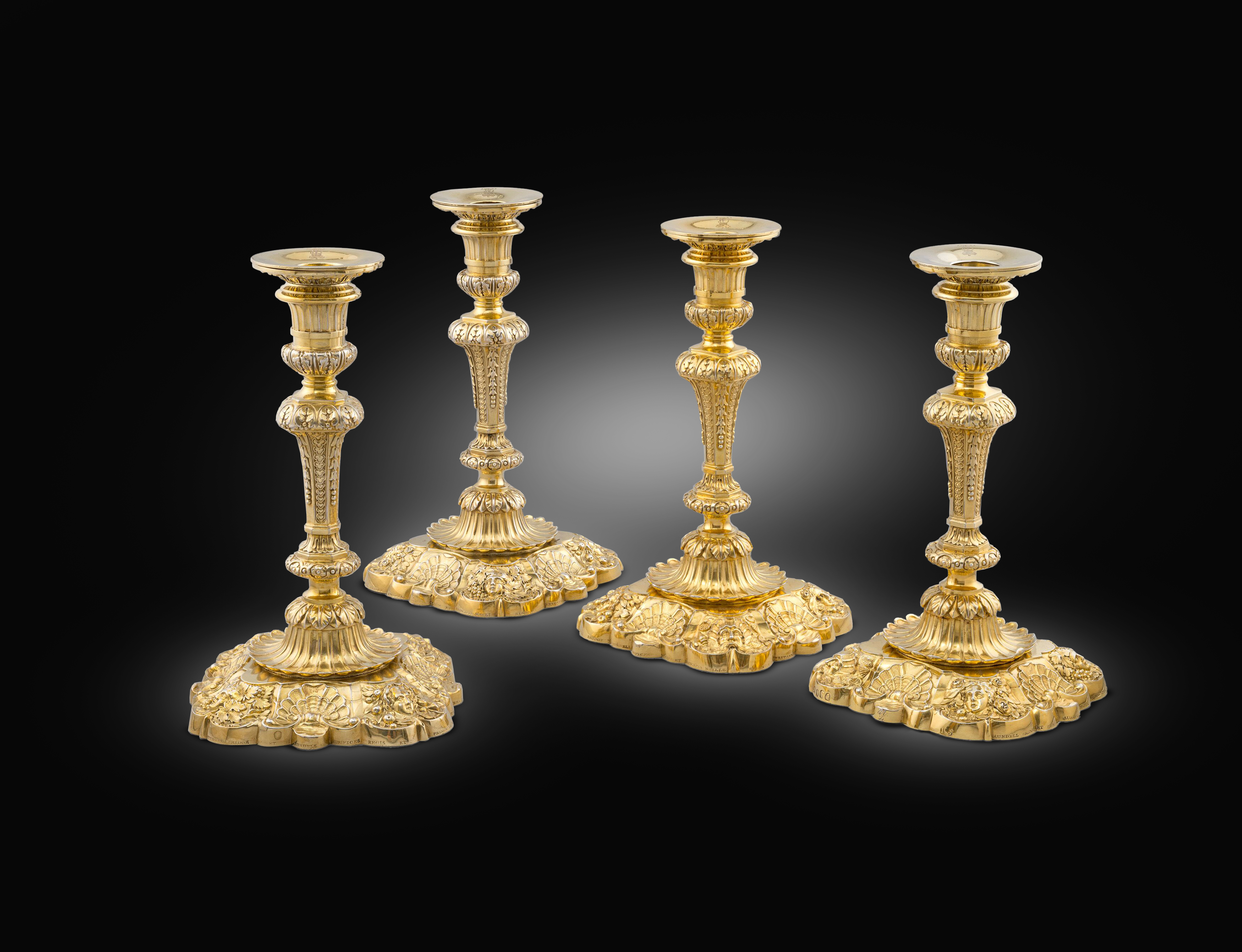 An Important Set of Four Silver-Gilt Royal Candlesticks