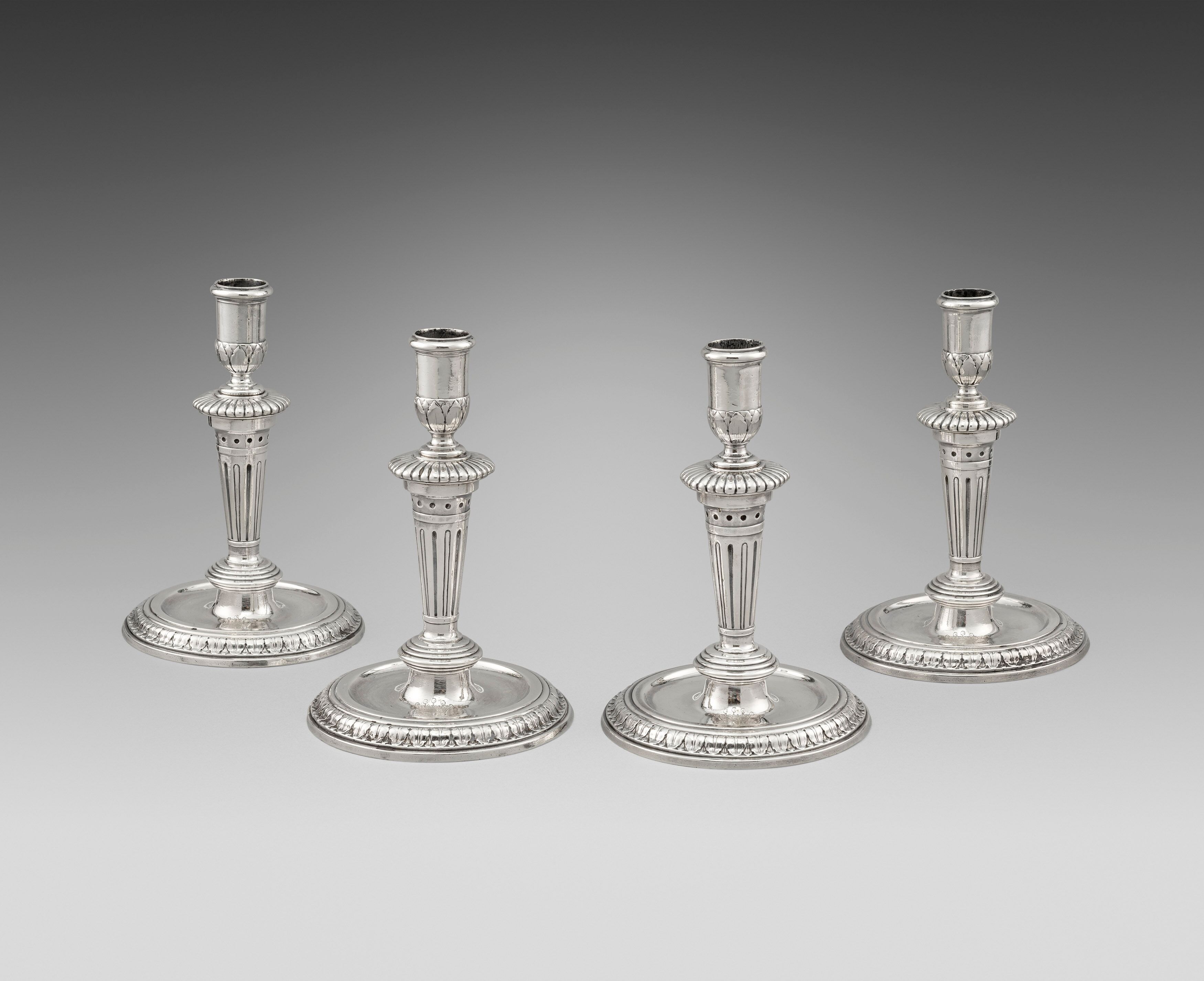 A Set of Four Queen Anne Candlesticks