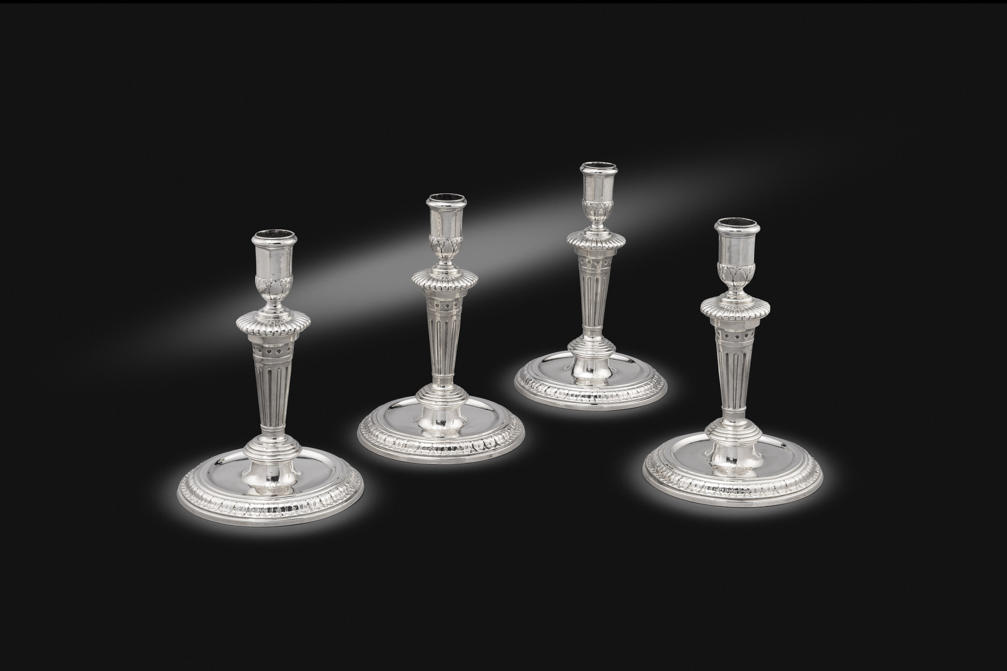 A Set of Four Queen Anne Candlesticks
