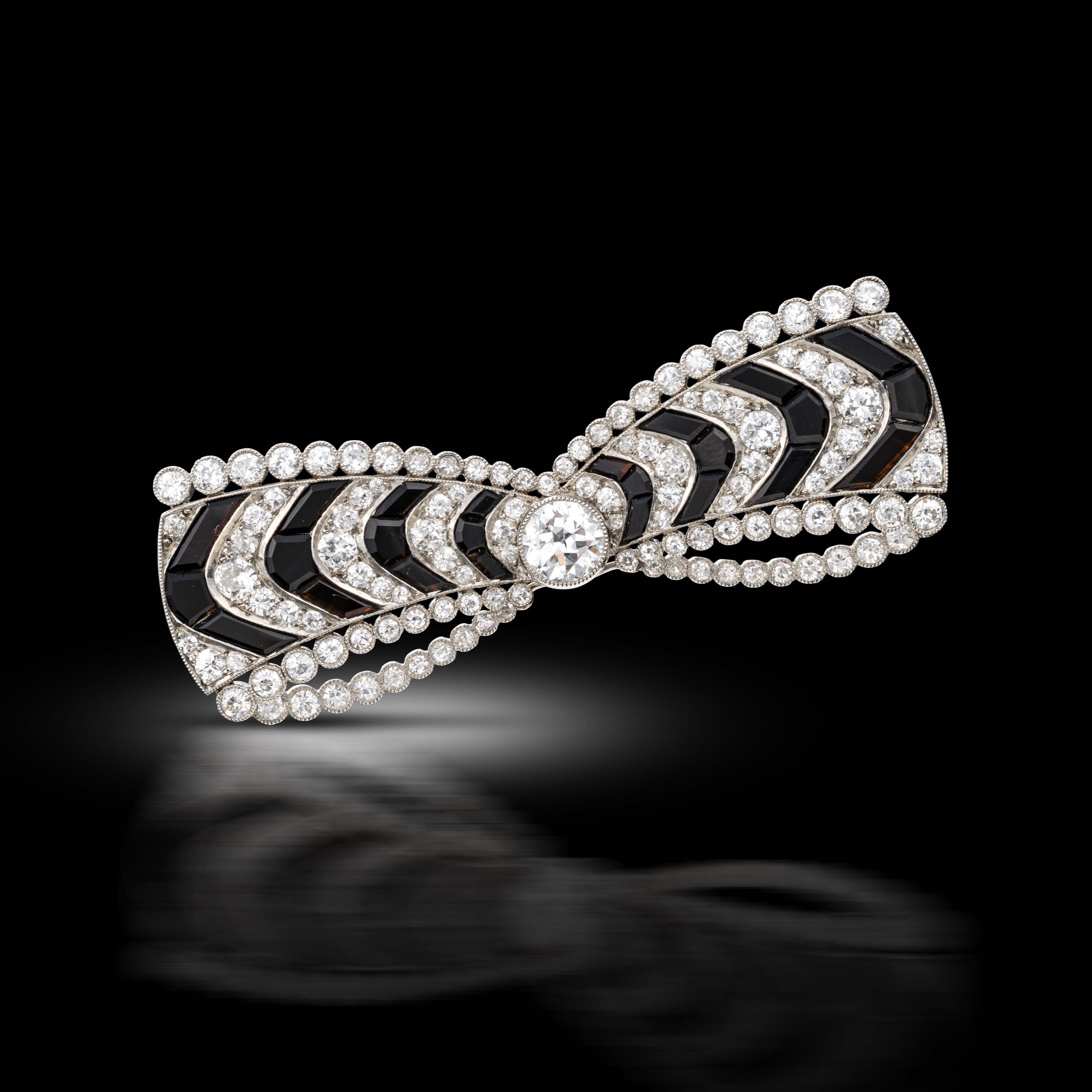 A diamond an onyx bow brooch, circa 1915