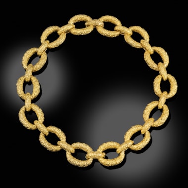 A gold and diamond necklace / pair of bracelets