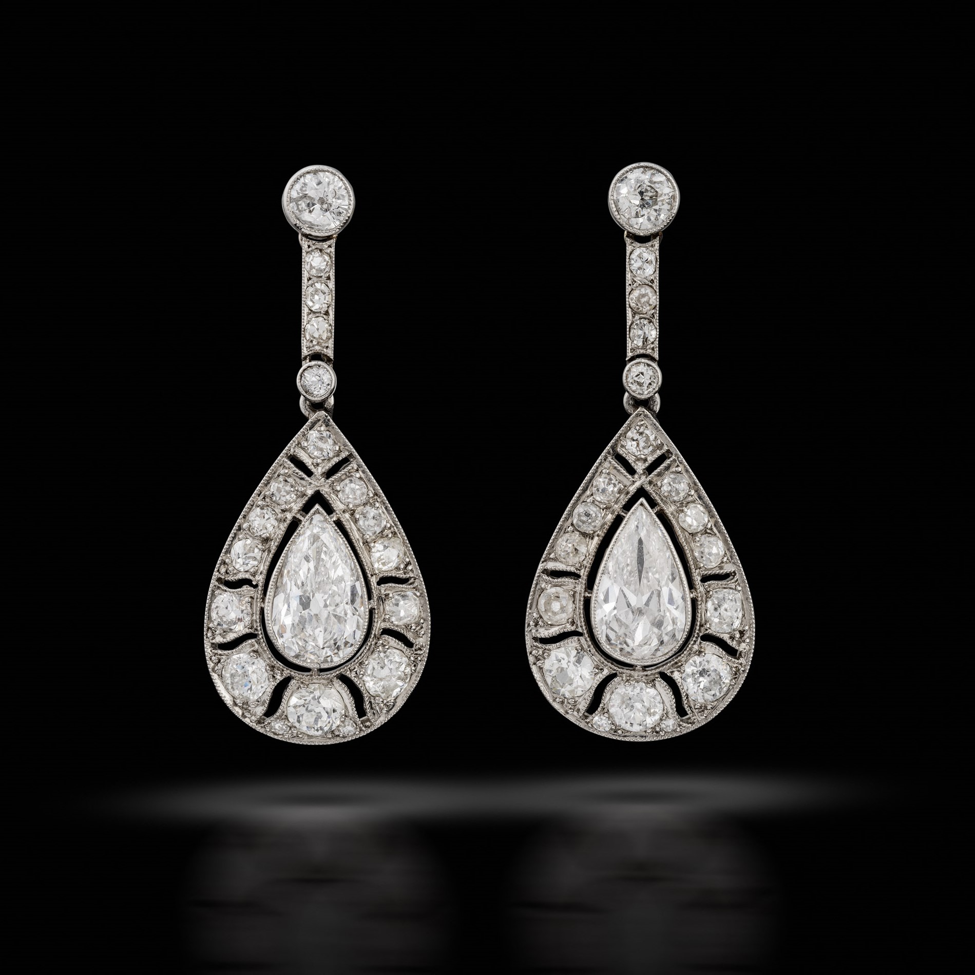 A pair of antique pear cut diamond earrings, circa 1915