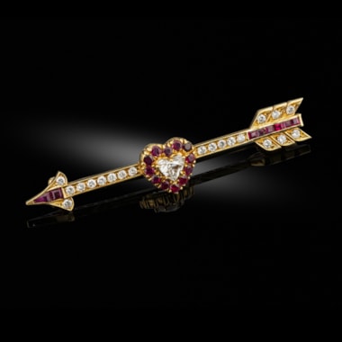 An early 20th century ruby and diamond arrow and heart brooch