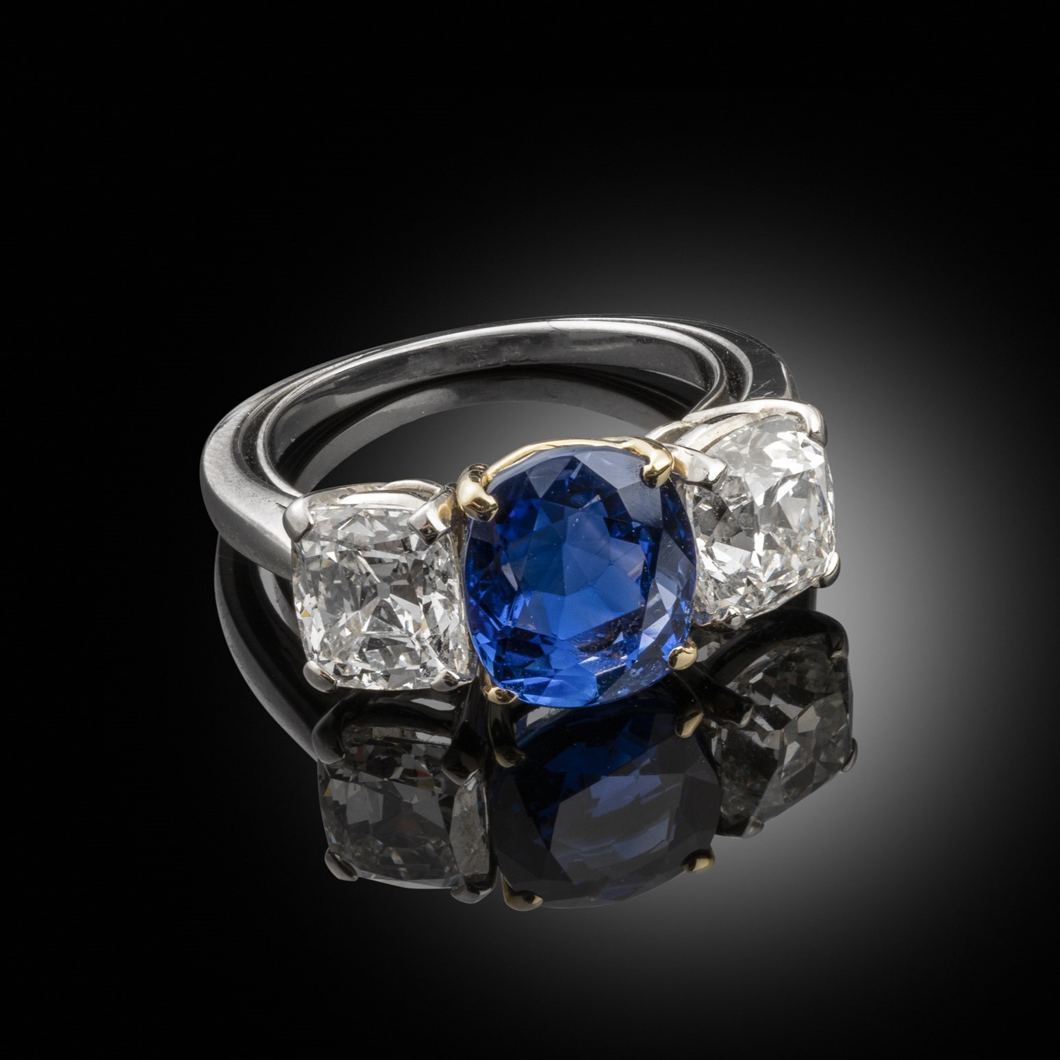Three stone cushion cut sapphire and diamond ring
