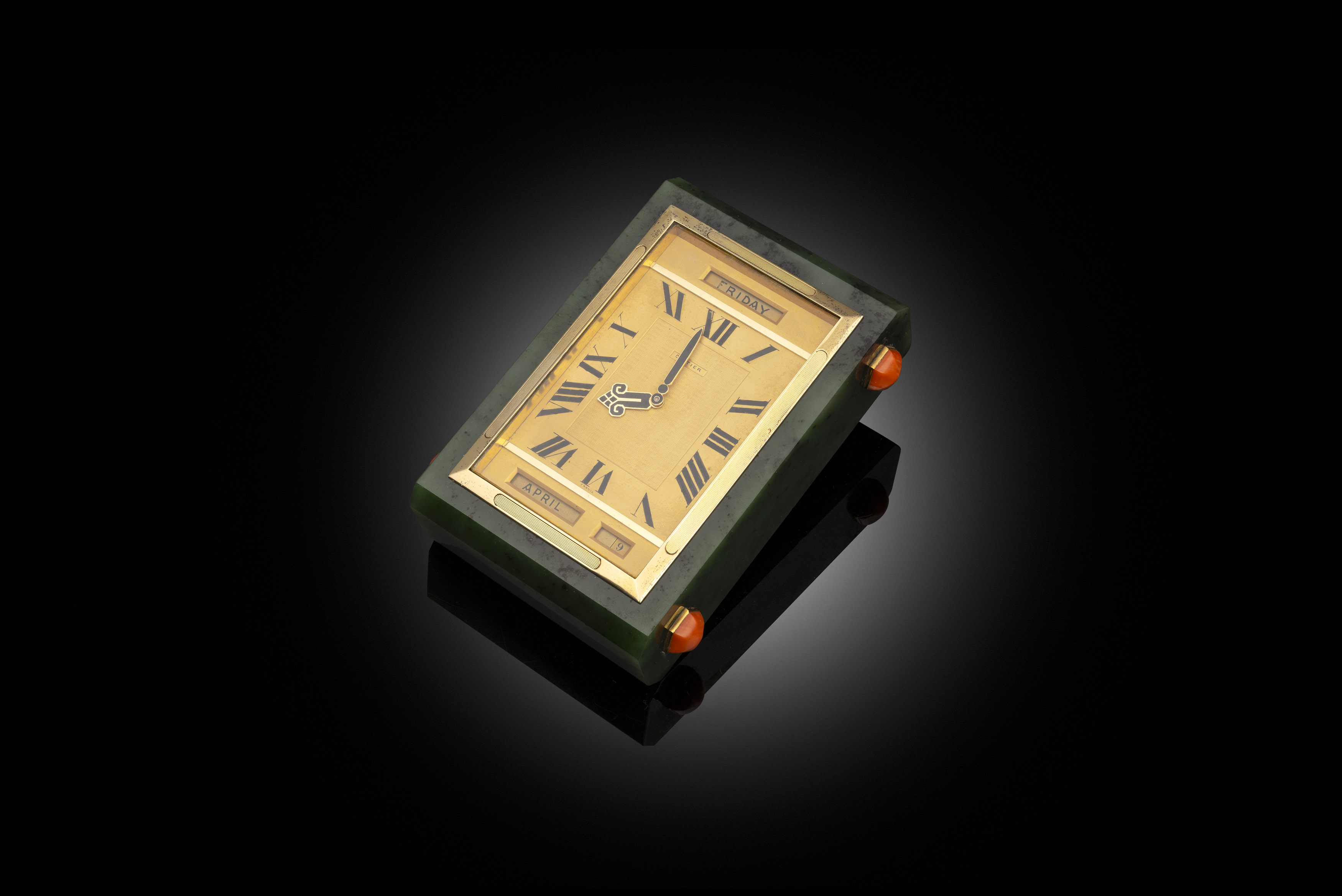 A Cartier Art Deco Gilt-Metal & Coral-Mounted Nephrite Paperweight Clock & Calendar